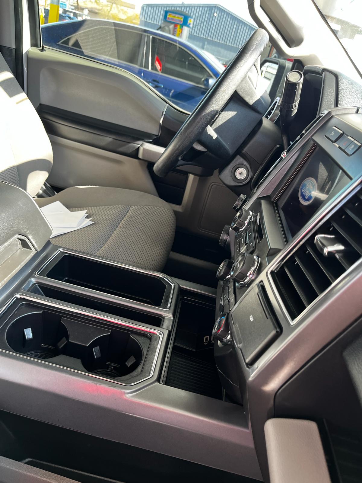 Clean center console and cup holders of a Ford truck interior